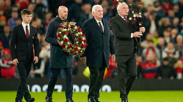 Manchester United&#39;s head coach Erik ten Hag, second left, with Alexander Stepney English former player, second right, and Manchester United academy player Dan Gore lays flowers in memory of Sir Bobby Charlton prior the Champions League group A soccer match between Manchester United and Copenhagen at the Old Trafford stadium in Manchester, England, Tuesday, Oct. 24, 2023. (AP Photo/Dave Thompson)